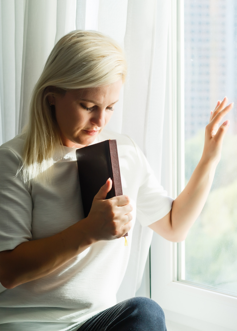 woman by the window praying