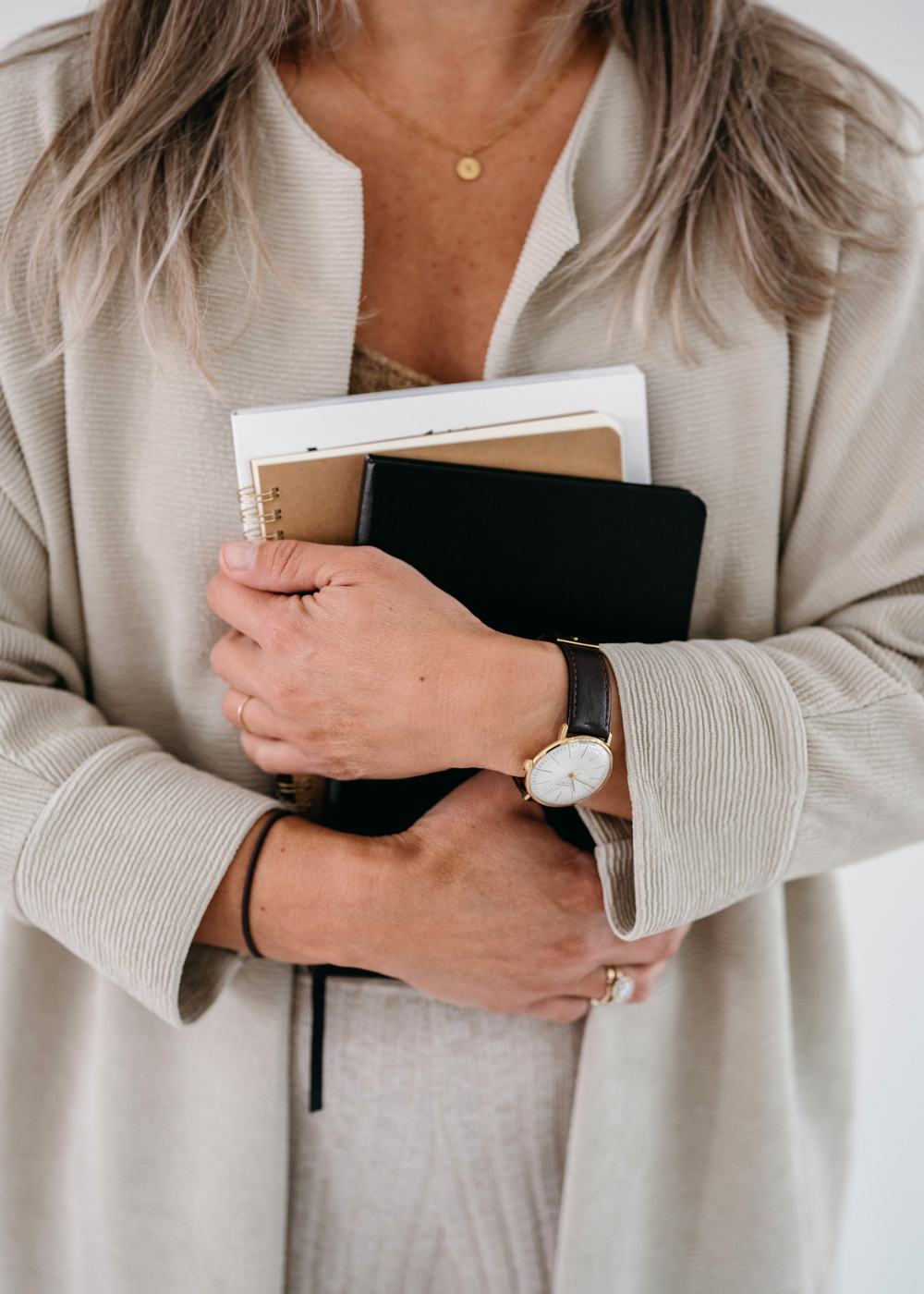 caucasian older woman holding books in her hand