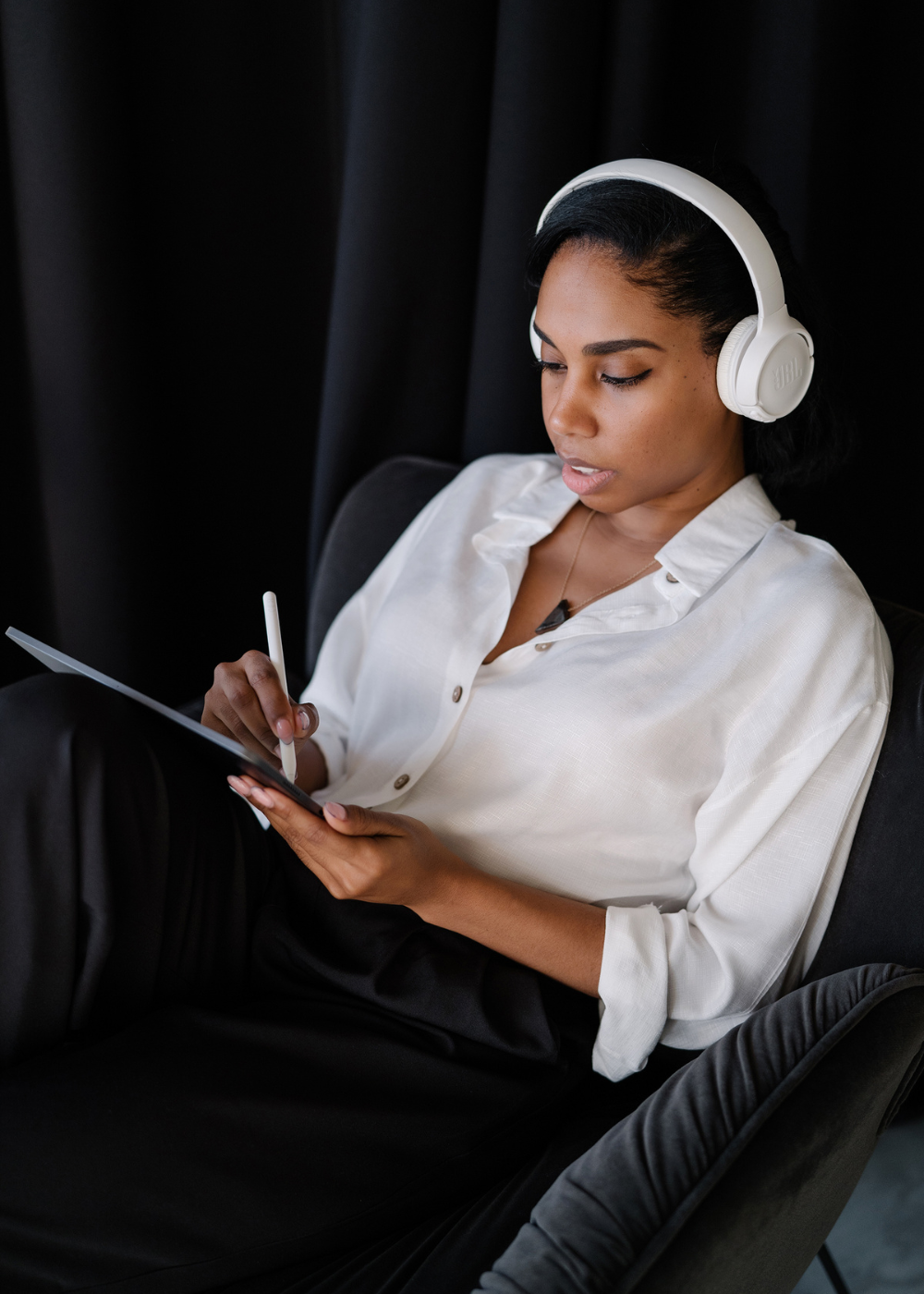 african american woman listening to a podcast