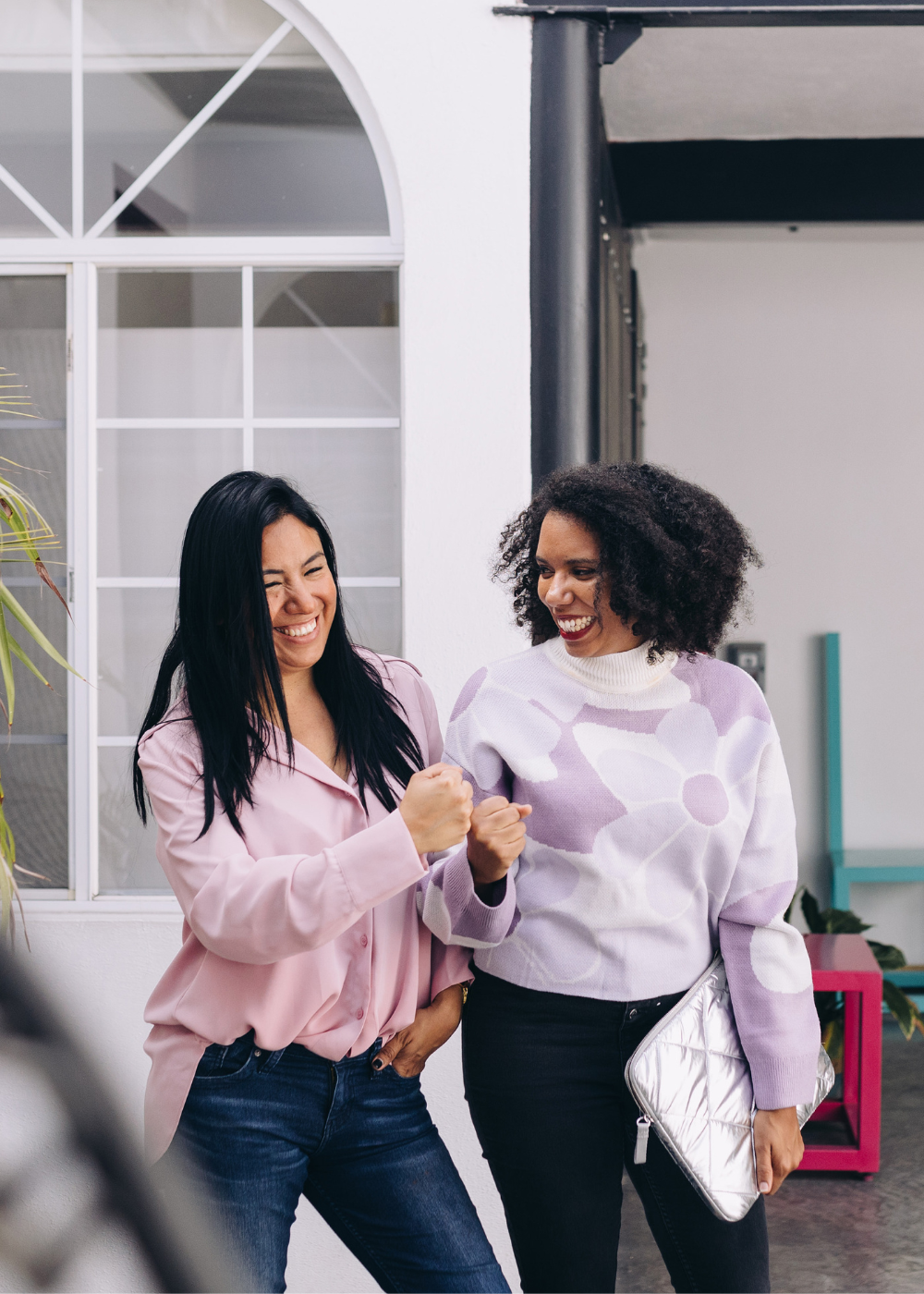 two women laughing outside