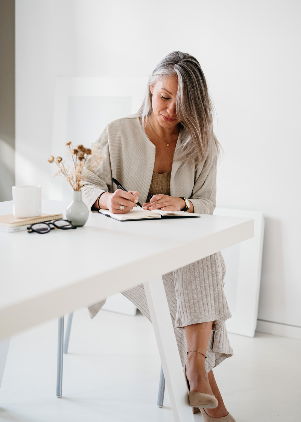 caucasian older woman writing on the table